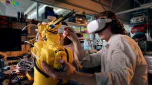 Young man and woman in VR glasses doing experiments in robotics in a laboratory. Robot and tools on the table, virtual reality - Starpik Stock