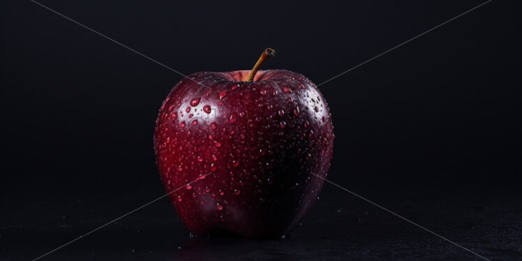 A black apple on a black background - Starpik Stock