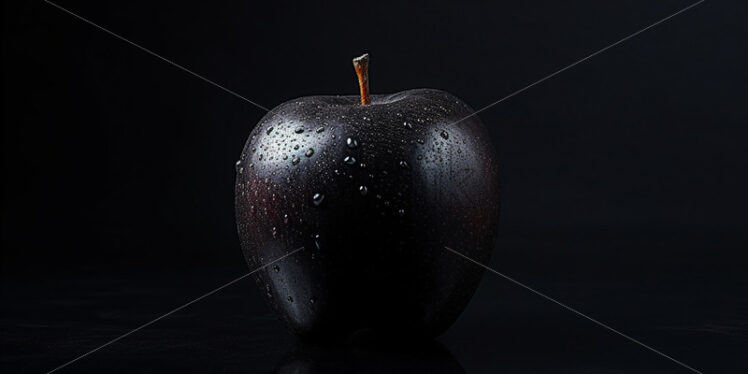 A black apple on a black background - Starpik Stock