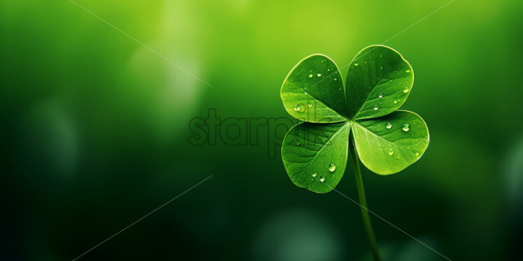 A four-leaf clover on a green background - Starpik Stock