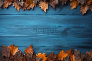 A frame of dry leaves formed on a blue wooden table - Starpik Stock