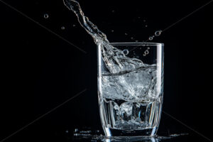 A glass of water on a black background - Starpik Stock