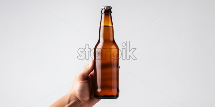 A hand holding a beer bottle on a white background - Starpik Stock