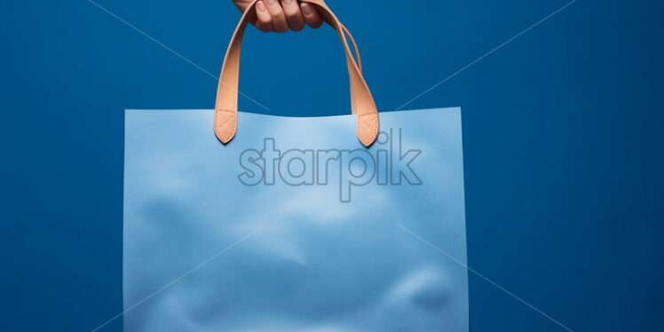 A shopping bag on a blue background - Starpik Stock