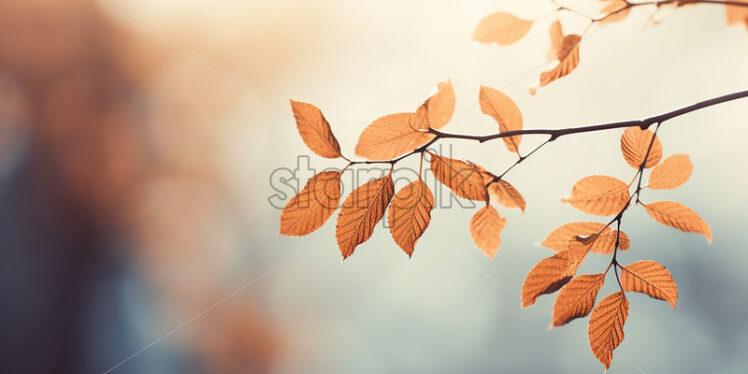 A twig with yellow leaves on a blurred background - Starpik Stock