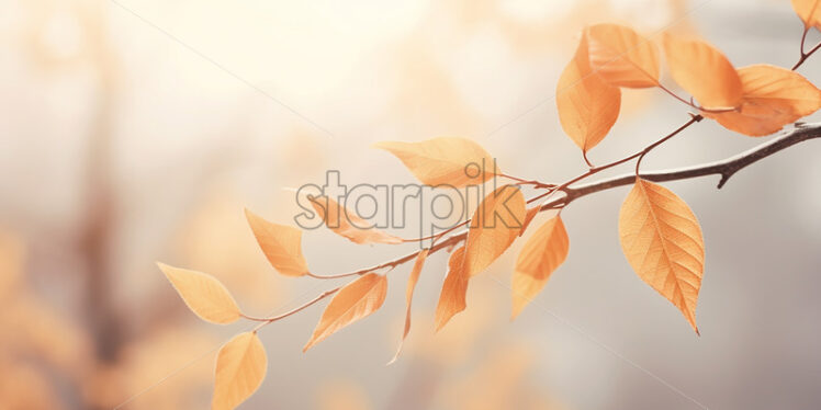 A twig with yellow leaves on a blurred background - Starpik Stock