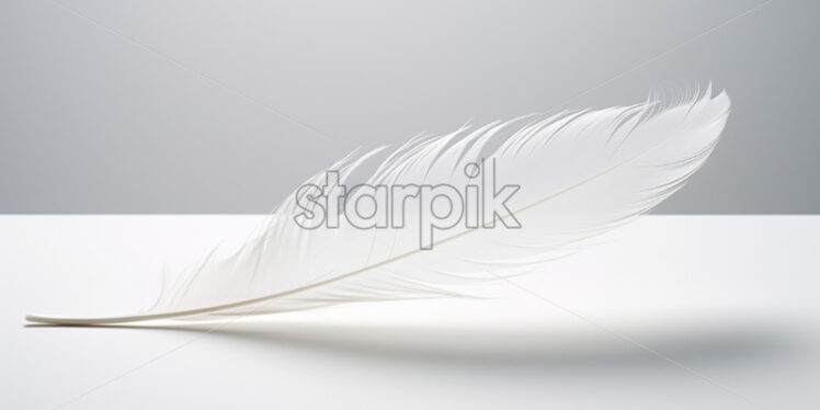 A white feather on a neutral surface - Starpik Stock