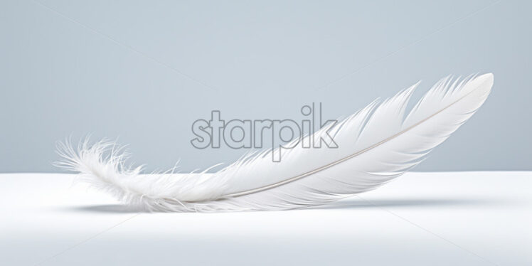 A white feather on a neutral surface - Starpik Stock