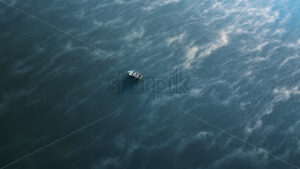 Aerial cinematic drone view of a man in a boat fishing on Nistru river at sunrise. Fog on the water in Moldova - Starpik Stock