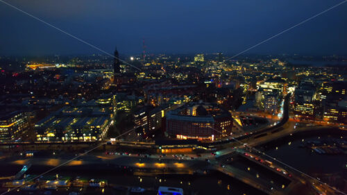 Aerial drone cinematic view of Hamburg city and port with harbour at night, Germany - Starpik Stock