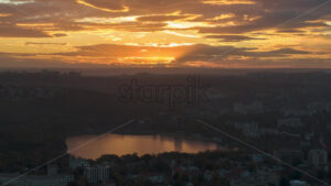 Aerial drone hyperlapse timelapse of sunset above Chisinau. Valea Morilor lake. Moldova - Starpik Stock