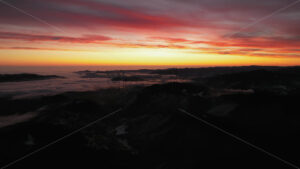 Aerial drone view of sunrise in the mountains. Ceahlau National Park, Romania - Starpik Stock