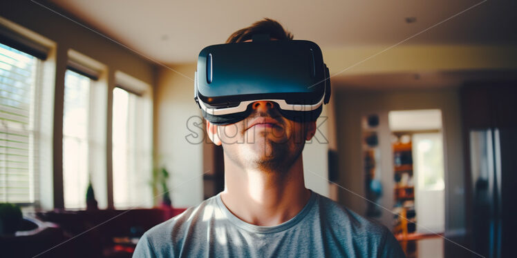 American man happily wearing virtual reality goggles in their living room - Starpik Stock