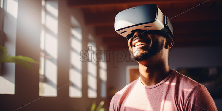 Black american man enjoying his virtual reality goggles in their entertainment room surrounded by some of the greenery plant  - Starpik Stock