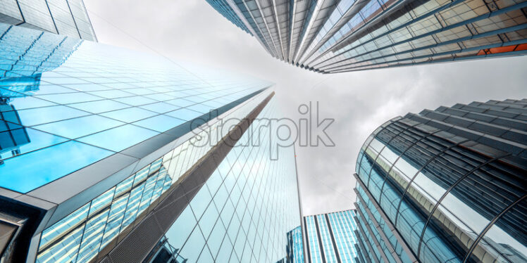Bottom-up view of London City financial district with multiple skyscrapers, United Kingdom - Starpik Stock