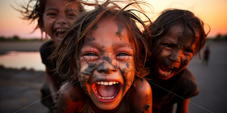 Cambodian Children enjoying the mud while playing in the beach during sunset - Starpik Stock