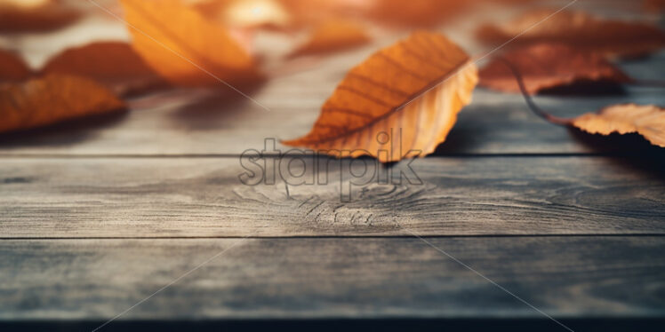 Dry yellow leaves on a wooden table - Starpik Stock