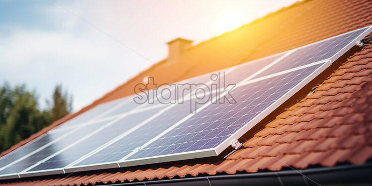 Photovoltaic panels on the tile roof of a house - Starpik Stock