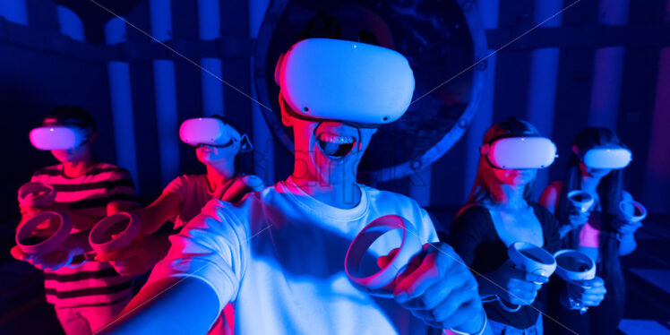 Premium Stock Photo – A team of young friends taking selfie while using virtual reality VR equipment on an arena. Neon lights - Starpik Stock