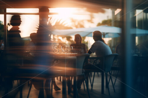 The blurred silhouettes of some people in a restaurant - Starpik Stock