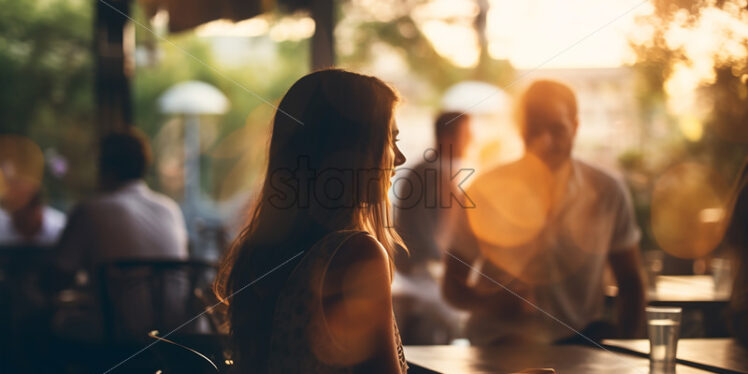 The blurred silhouettes of some people in a restaurant - Starpik Stock