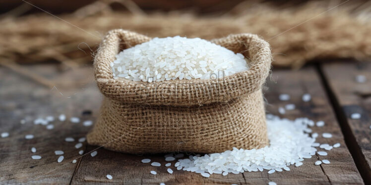 A bag of white rice on a wooden table - Starpik Stock