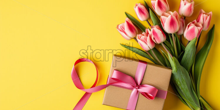 A bouquet of tulips and a gift on a yellow background - Starpik Stock