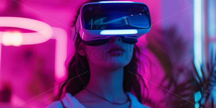 A cute girl having a virtual meeting with their colleagues in Vr glasses - Starpik Stock