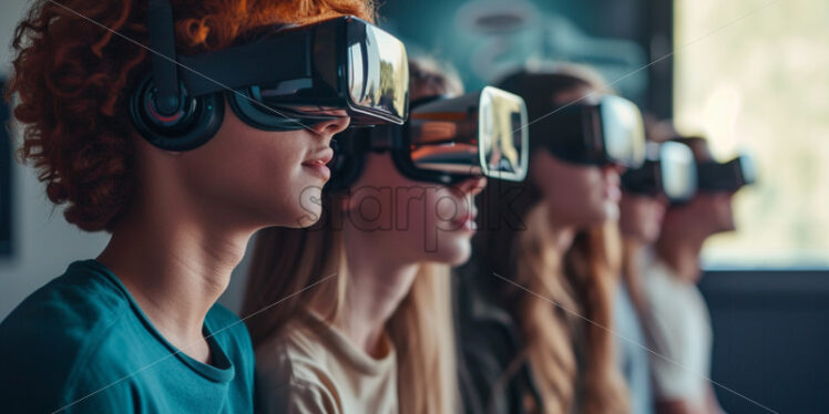 A group of teenagers wearing VR glasses, office concept - Starpik Stock