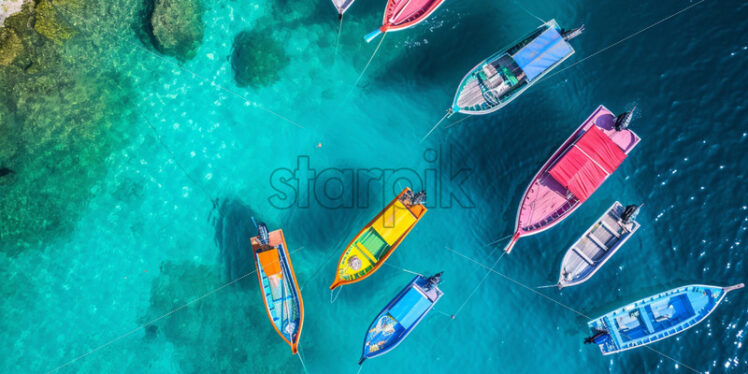 Aerial view of colorful boats on turquoise sea - Starpik Stock