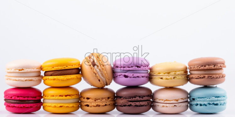 Assortment of colorful macarons, on isolated white background - Starpik Stock