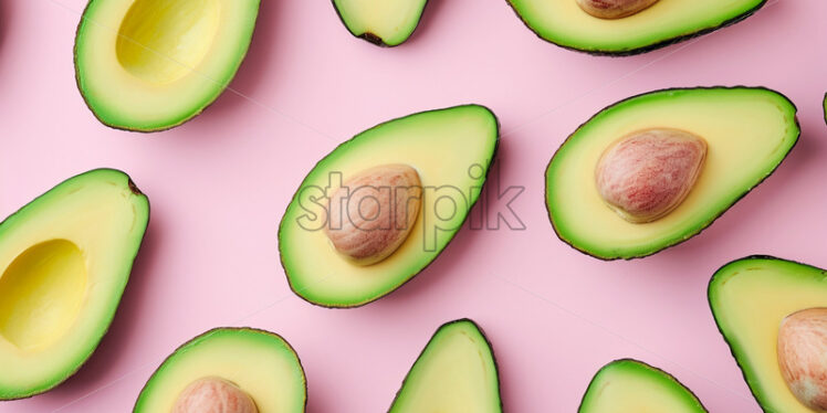 Avocado slices neatly arranged on a pink background - Starpik Stock