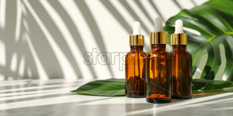 Brown glass bottles with gold lid, standing on table with tropical leaf - Starpik Stock