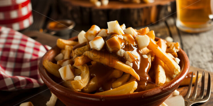 Classic Canadian Poutine in a bowl - Starpik Stock