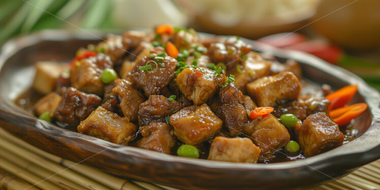 Filipino tofu and pork on a bamboo table, professionally photographed with native-style plating - Starpik Stock