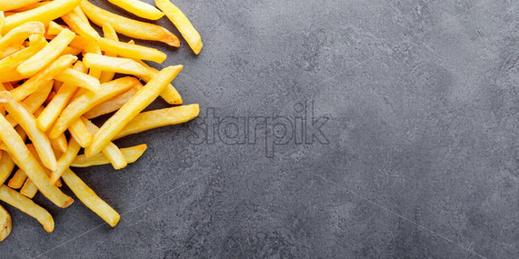 French fries on a gray concrete surface - Starpik Stock