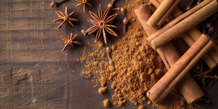 Ground cinnamon and whole cloves on a wood surface - Starpik Stock