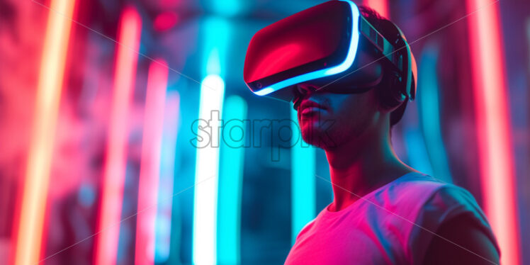 Man with VR glasses in neon lights - Starpik Stock