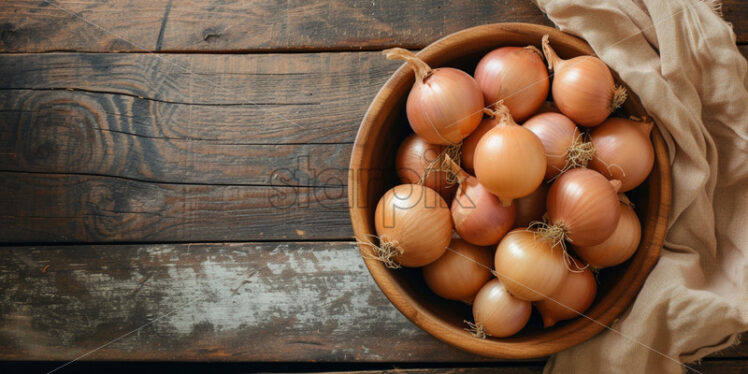 Onions in a wooden bowl on a table - Starpik Stock