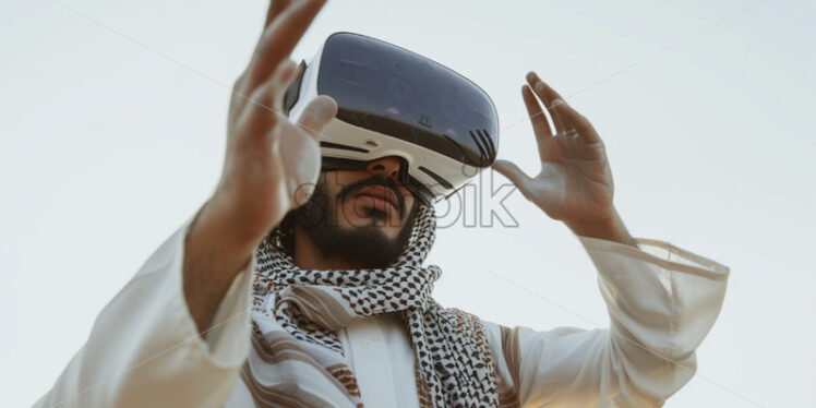 Saudi youth male using VR glasses - Starpik Stock