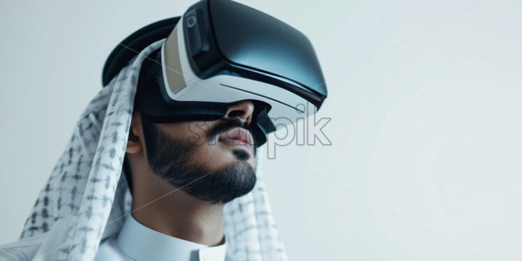 Saudi youth male using VR glasses - Starpik Stock