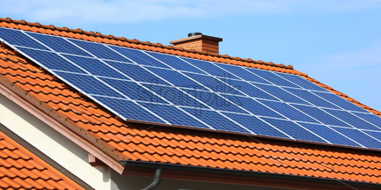 Solar panels on the roof of a tile house - Starpik Stock