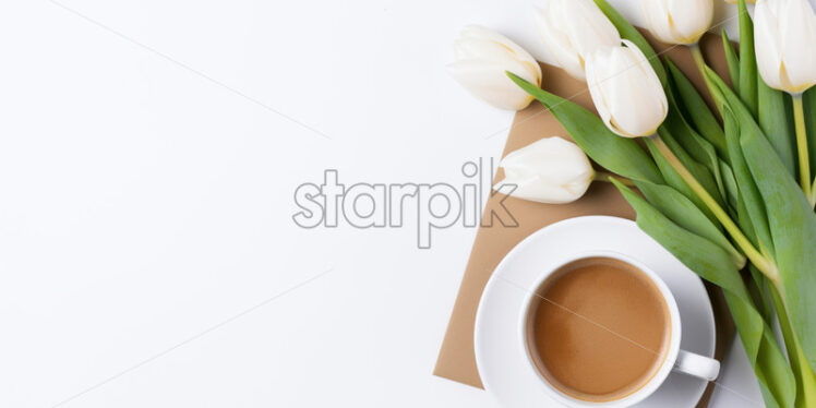 Top view cup of coffee, white tulips - Starpik Stock