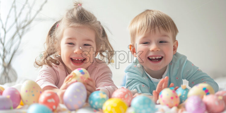 Two happy children are cracking pastel easter eggs - Starpik Stock