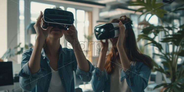 Two people playing with VR glasses in an office - Starpik Stock