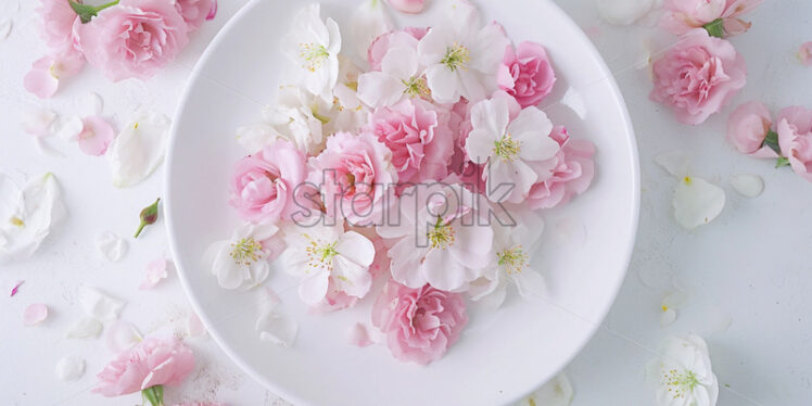 White plate with flowers. Creative composition - Starpik Stock