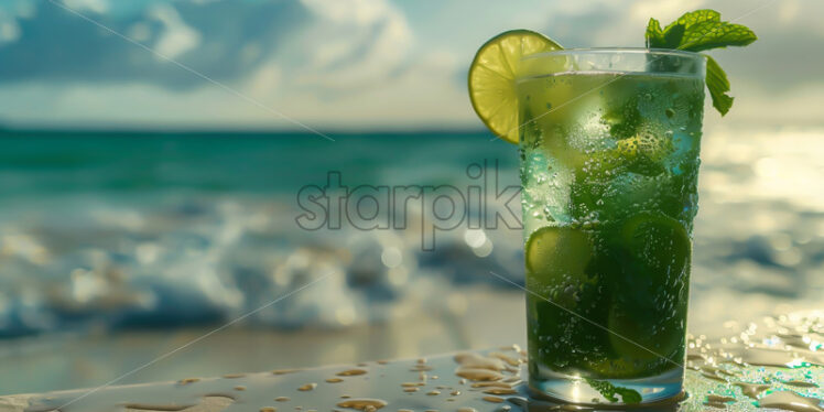 A glass of cold mojito, against the background of a beach - Starpik Stock