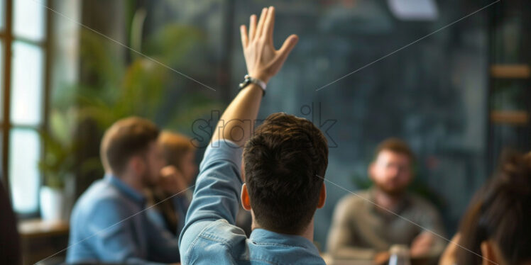 A man in the office with his hand raised - Starpik Stock