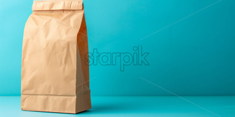 A paper bag on a blue background - Starpik Stock