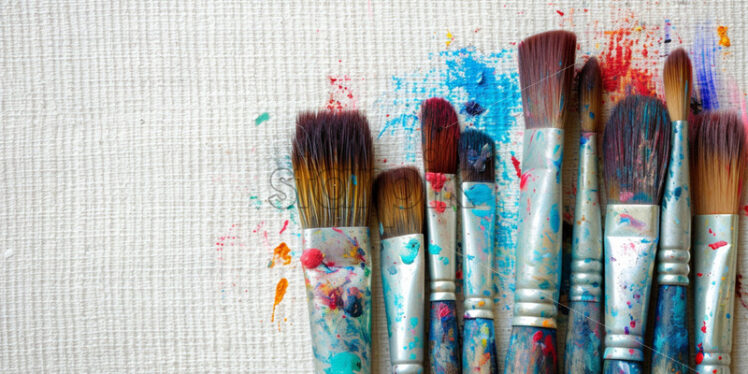 A set of dirty brushes on a canvas - Starpik Stock